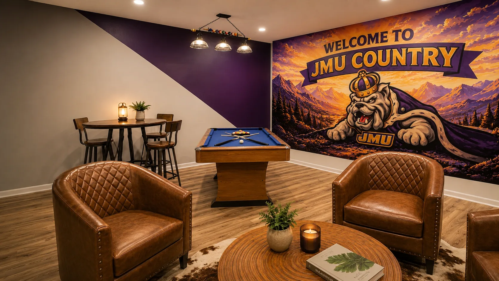 Game room at Cedar Escape with pool table, leather chairs, and Welcome to JMU Country mural