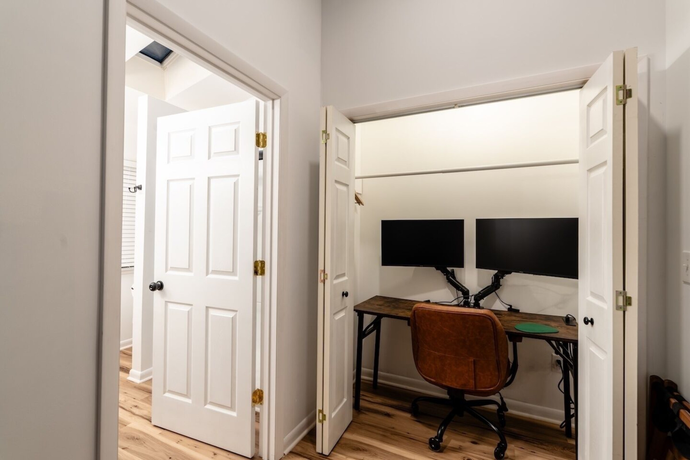 Emerald Room workspace with dual monitors at Cedar Escape
